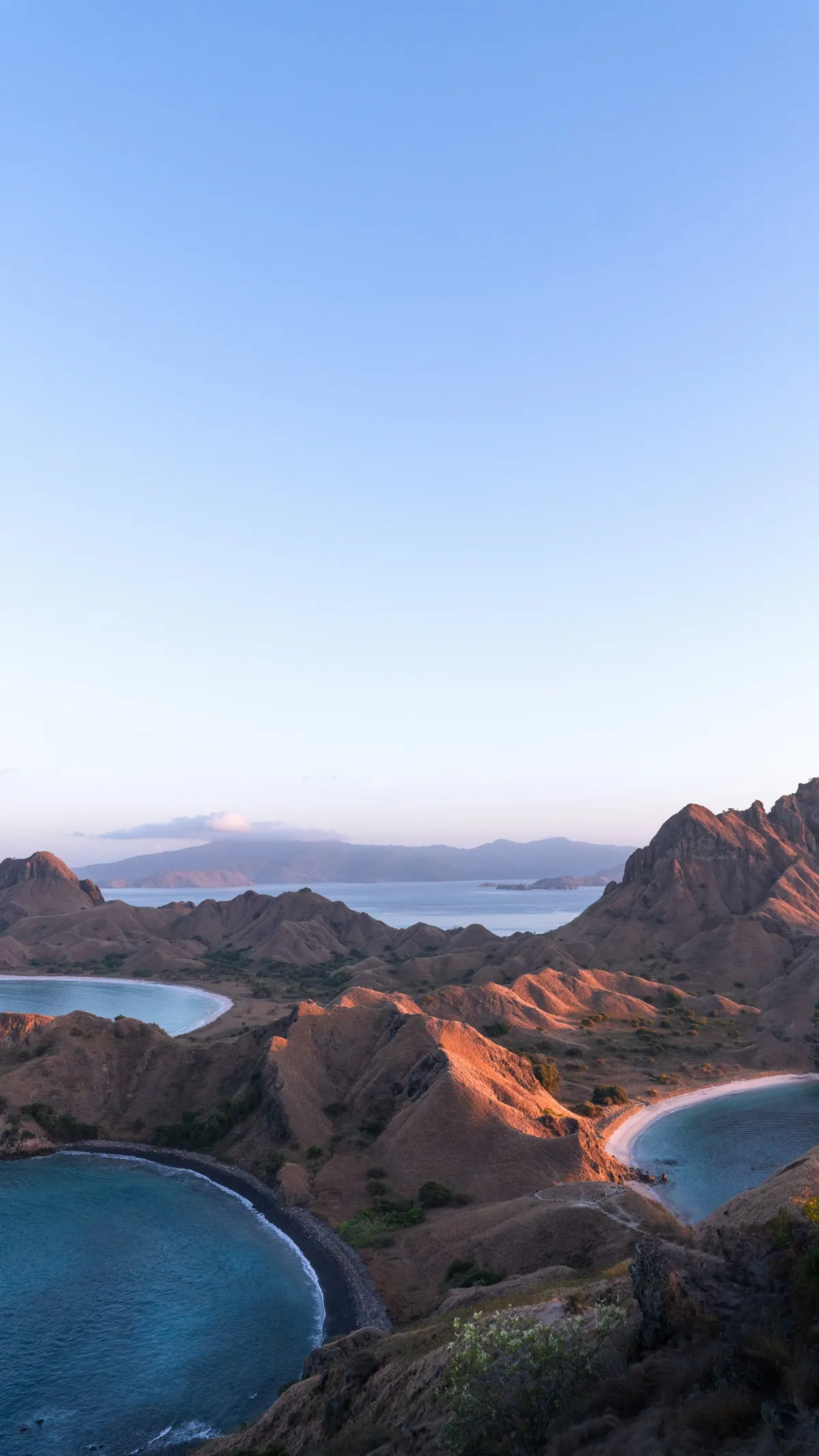 a scenic view of a beach and a body of water