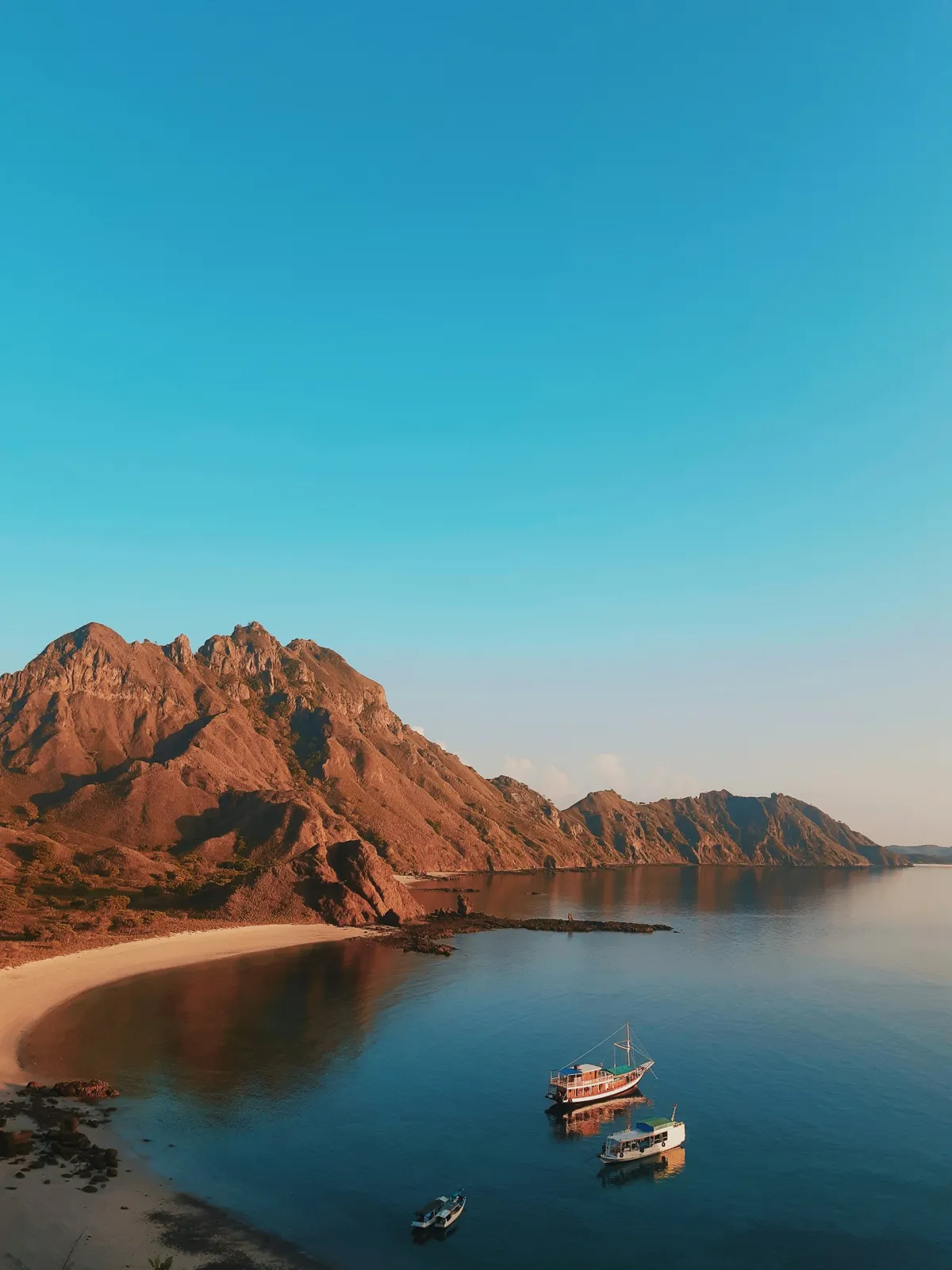 brown and white boat on body of water during daytime